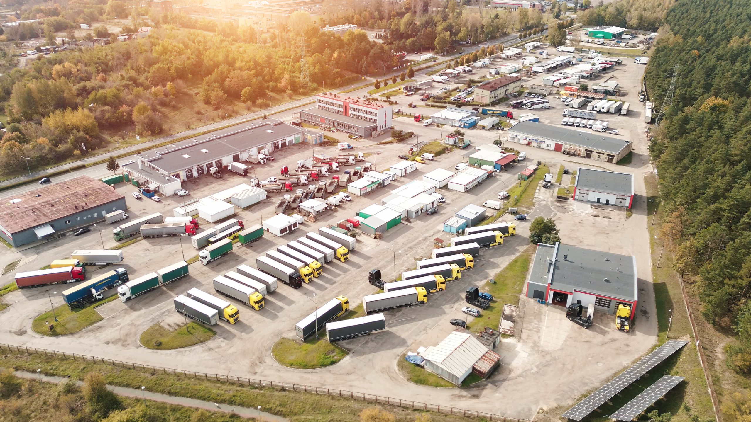 Truck fleet parked at warehouse facility