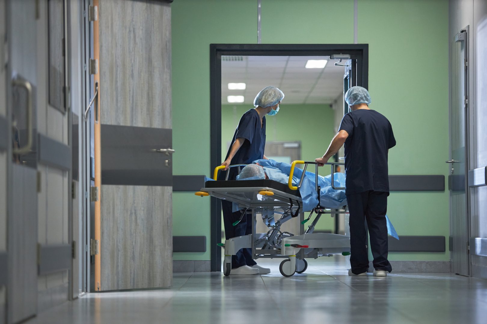 Medical Team Transporting Patient on Gurney through Hospital Corridor