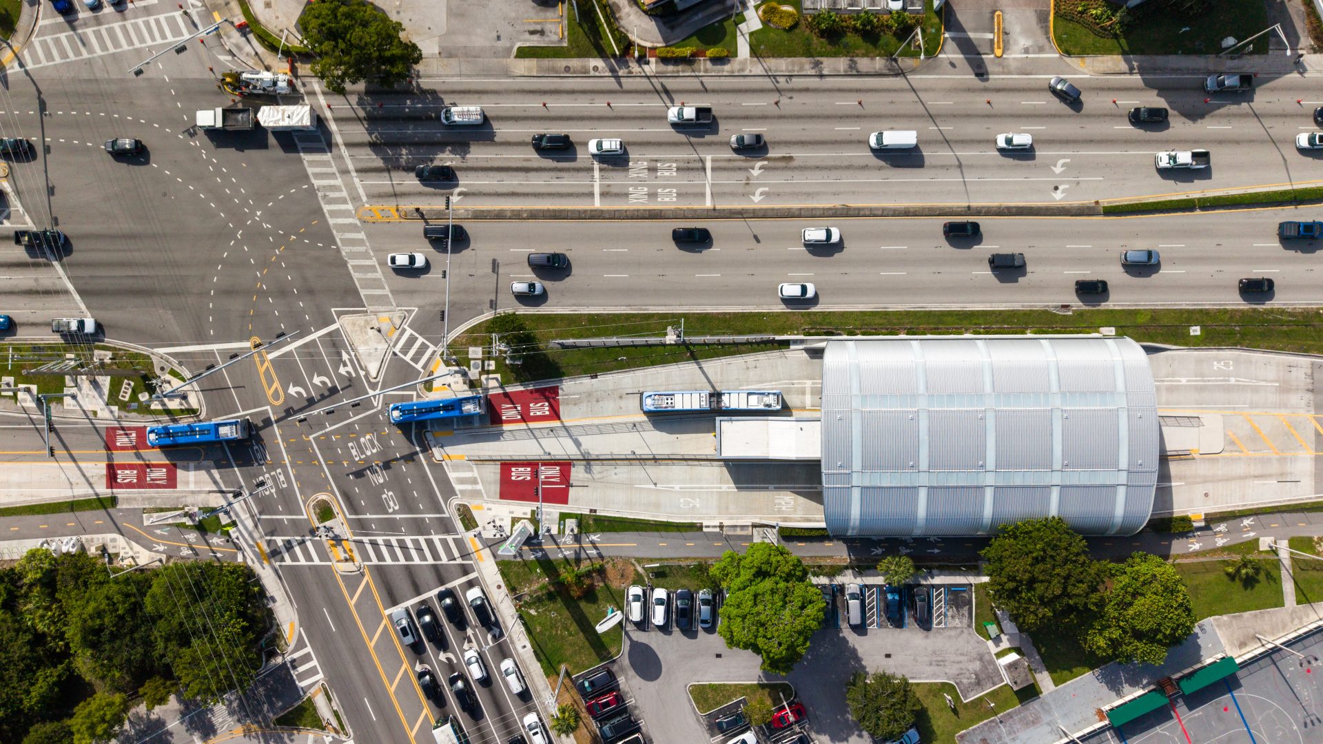 Aerial Top-Down View of Urban Transit Station with Bus Rapid Transit Lanes and City Traffic
