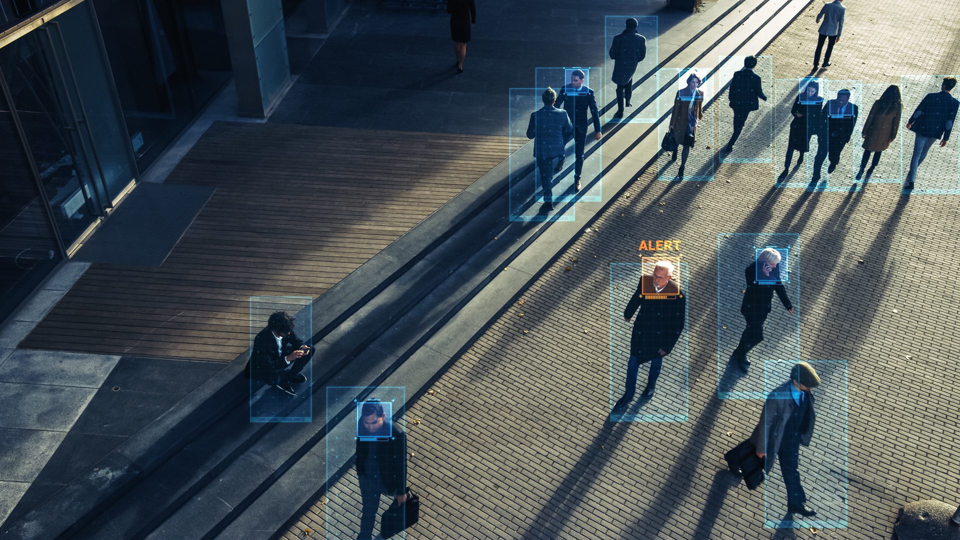 Elevated Security Camera Surveillance Footage of a Crowd of People Walking on Busy Urban City Streets. CCTV AI Facial Recognition Big Data Analysis Interface Scanning, Showing Private Information.